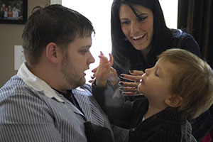 Mother And Father Helping Young Son With Speech And Language Pathology Therapy.