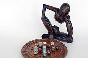 Wooden Figure Playing Chinese Checkers.