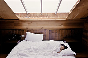 Girl Lying In Bed Under White Blanket.