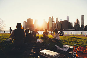 Employees Having A Picnic Near The Lake In The Summer.