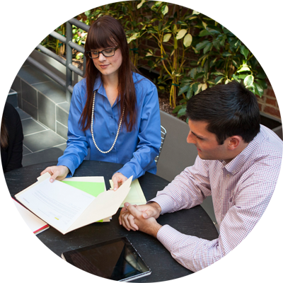 Business woman and businessman discussing implementing corporate wellness program.