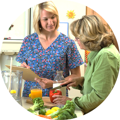 Dietitian cooking with female client.