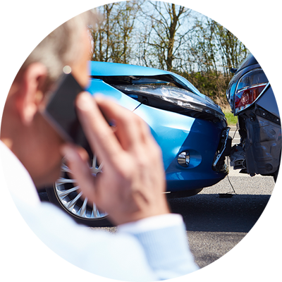 Man on phone looking at motor vehicle accident.