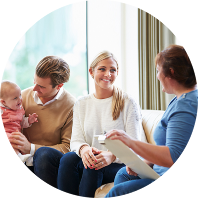 Social Worker speaking with mother while father holds child.