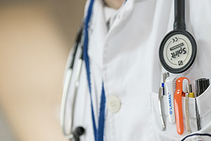 Close-up Of Doctor's White Jacket With Stethoscope And Pens In Pocket.