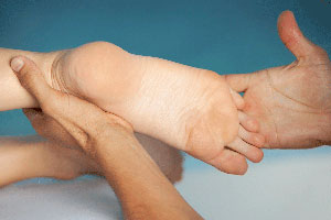 Nursing Foot Care: Nurses Holding And Examining Patient's Foot.