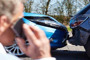 Man On Phone After Motor Vehicle Accident.