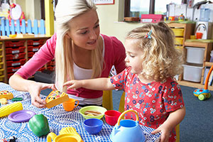 An Occupational Therapist Playing With A Female Child.