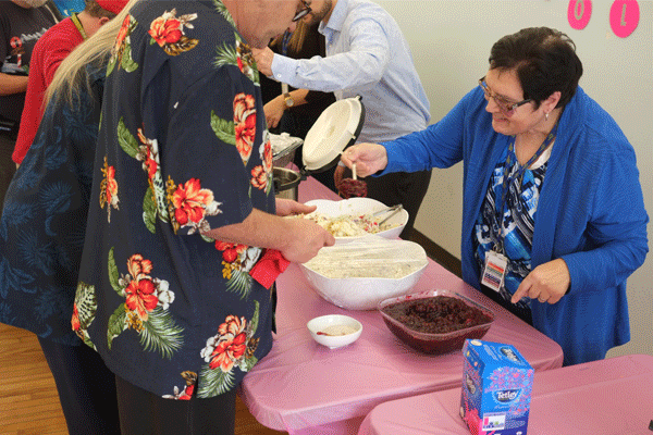 Closing The Gap Healthcare Staff Serving Lunch At Woodgreen Community Services.