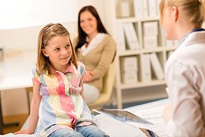 Speech Language Pathologist With Young Female Patient.