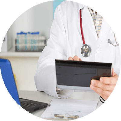 Doctor examining patient's blood pressure reading through machine.