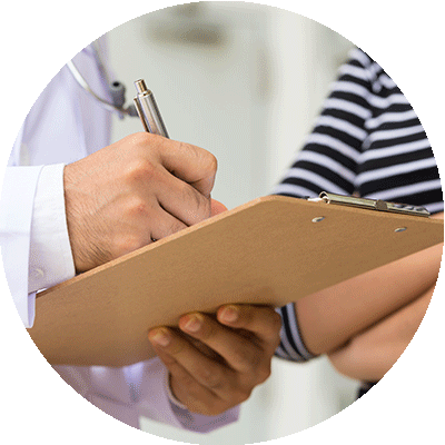 Close-up of doctor signing papers on clipboard.