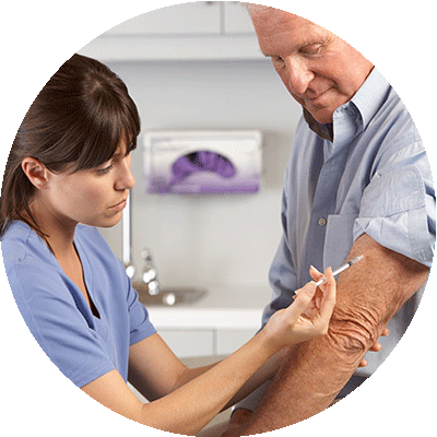 Nurse giving flu shot to man.