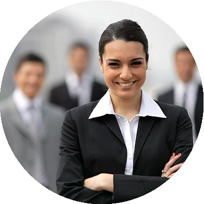 Close-up of smiling businesswoman in suit, standing in front of blurred business people.